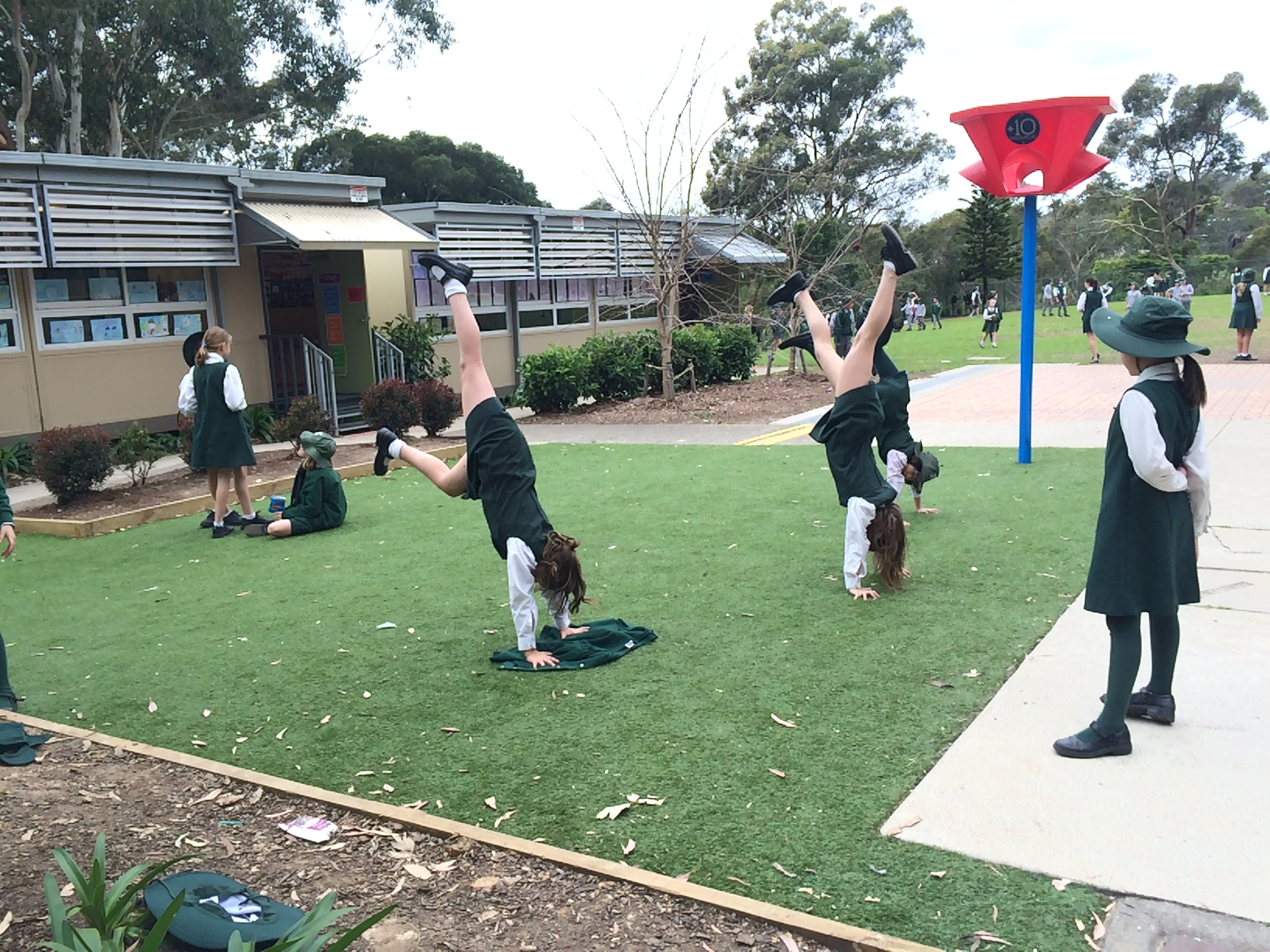 Children played gymnastics on a small grassed area, separate from the main oval. Ball games were restricted to the oval to prevent conflicts.