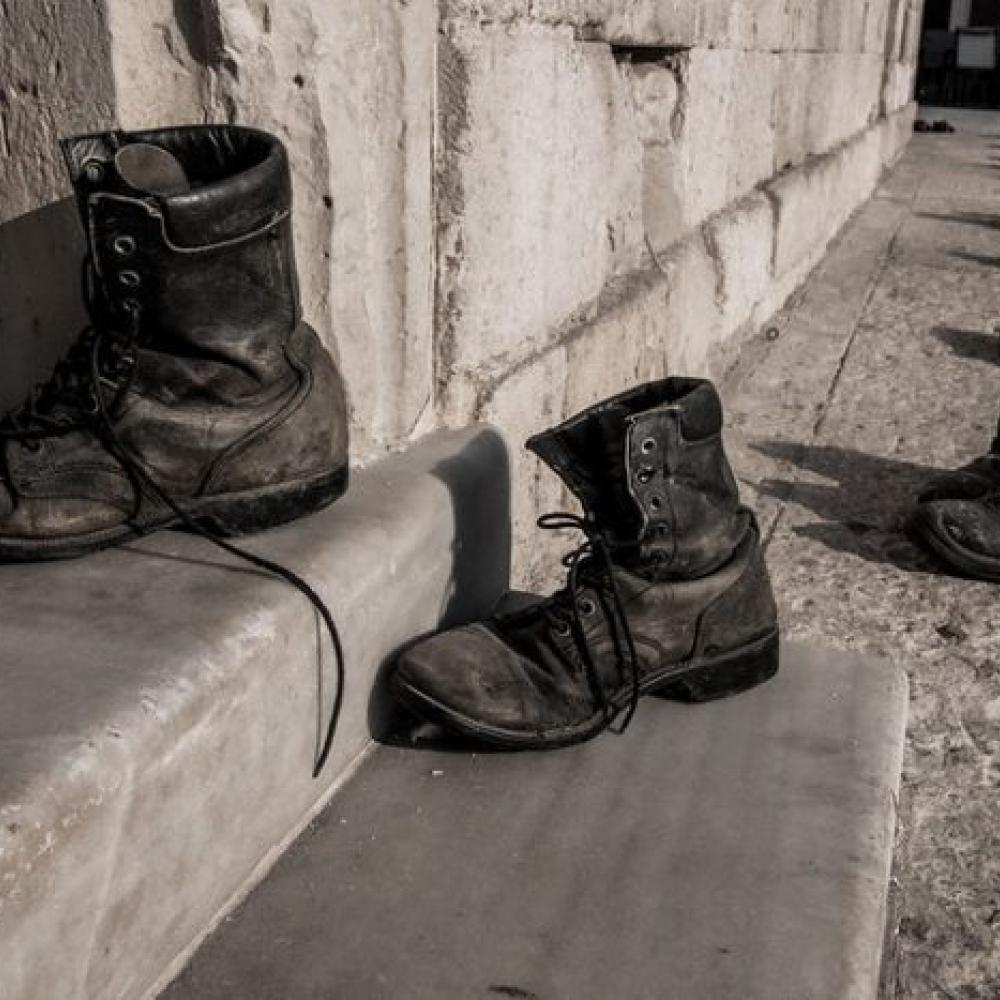 Shoes in a trail leading into a building