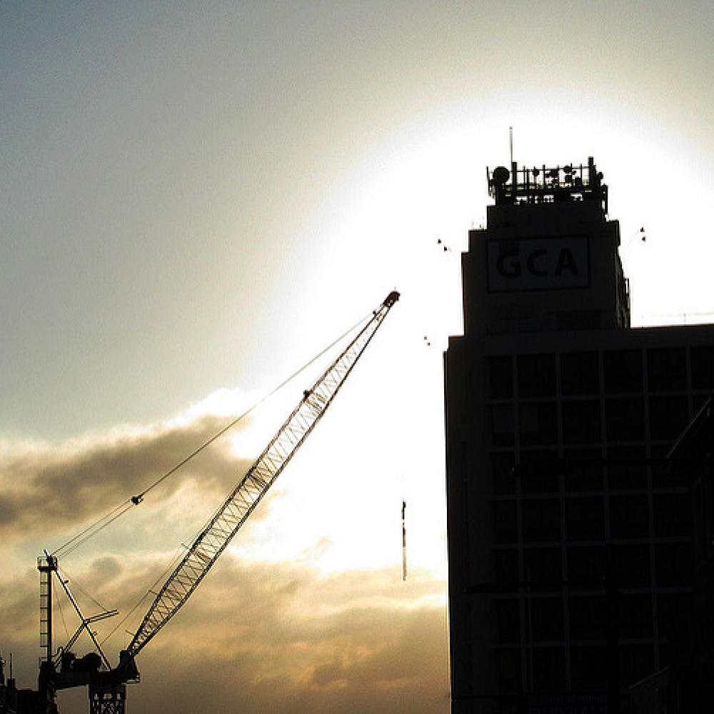 Silhouette of a tall building crane