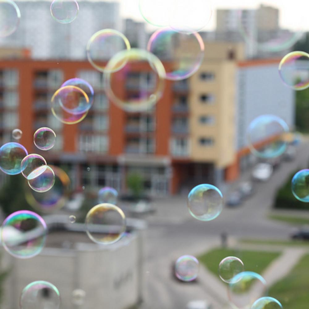 Bubbles flying in front of an apartment