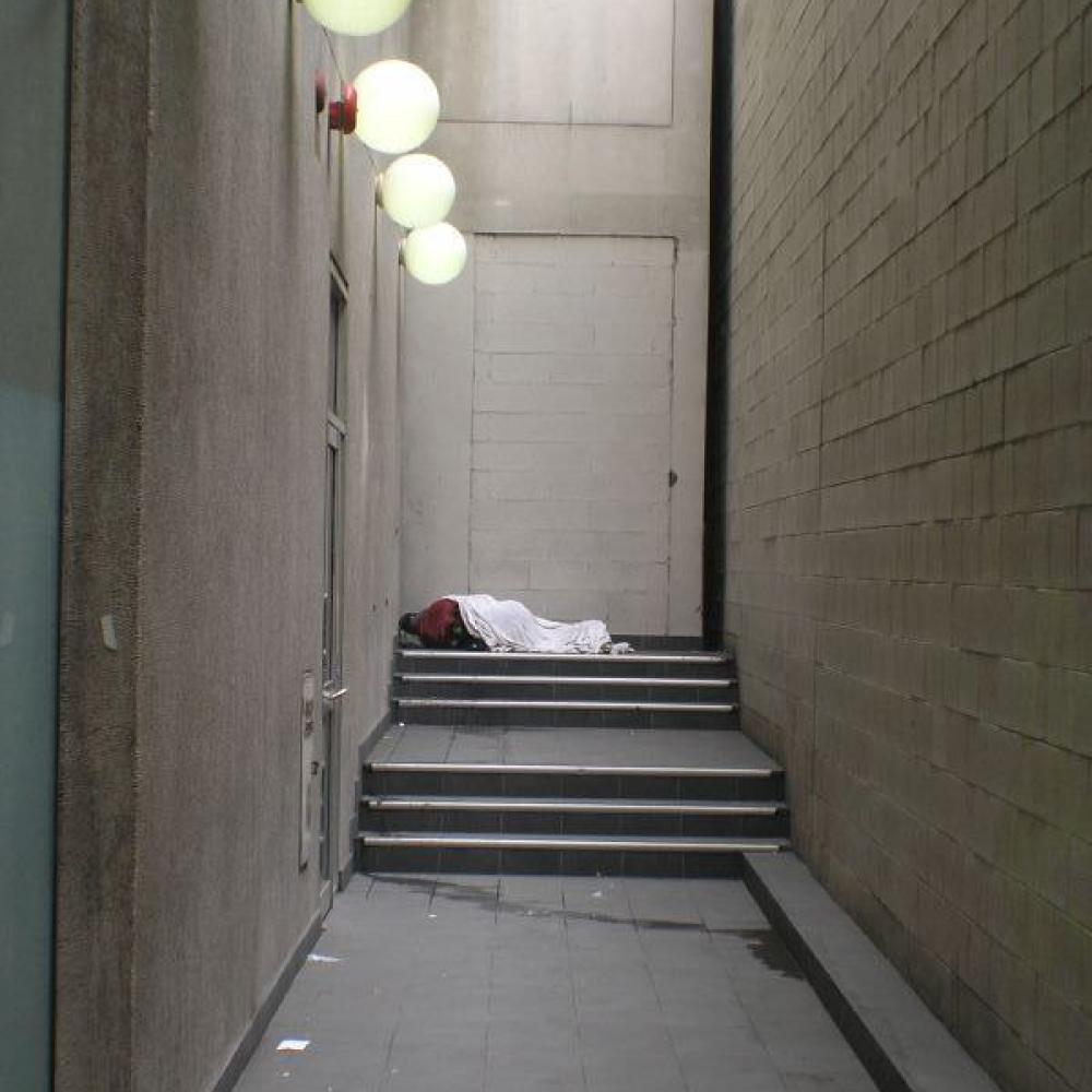 Homeless person sleeping on stairs