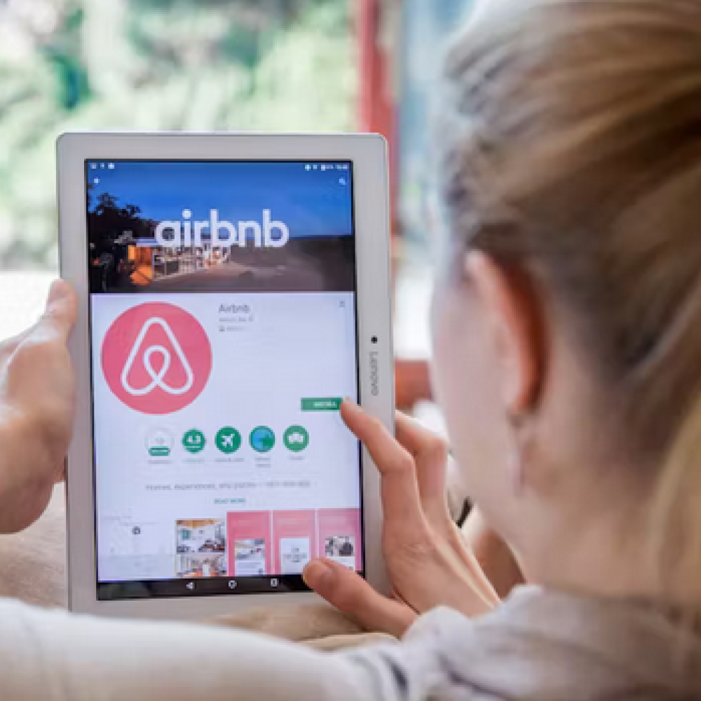 Woman using airbnb on a tablet