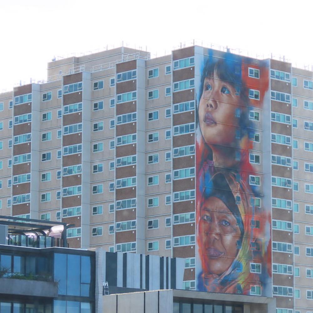 Apartment building with child painted on the side wall