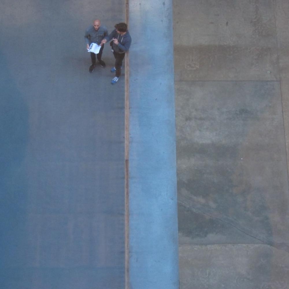 Eagle eye view of two people taling on the footpath