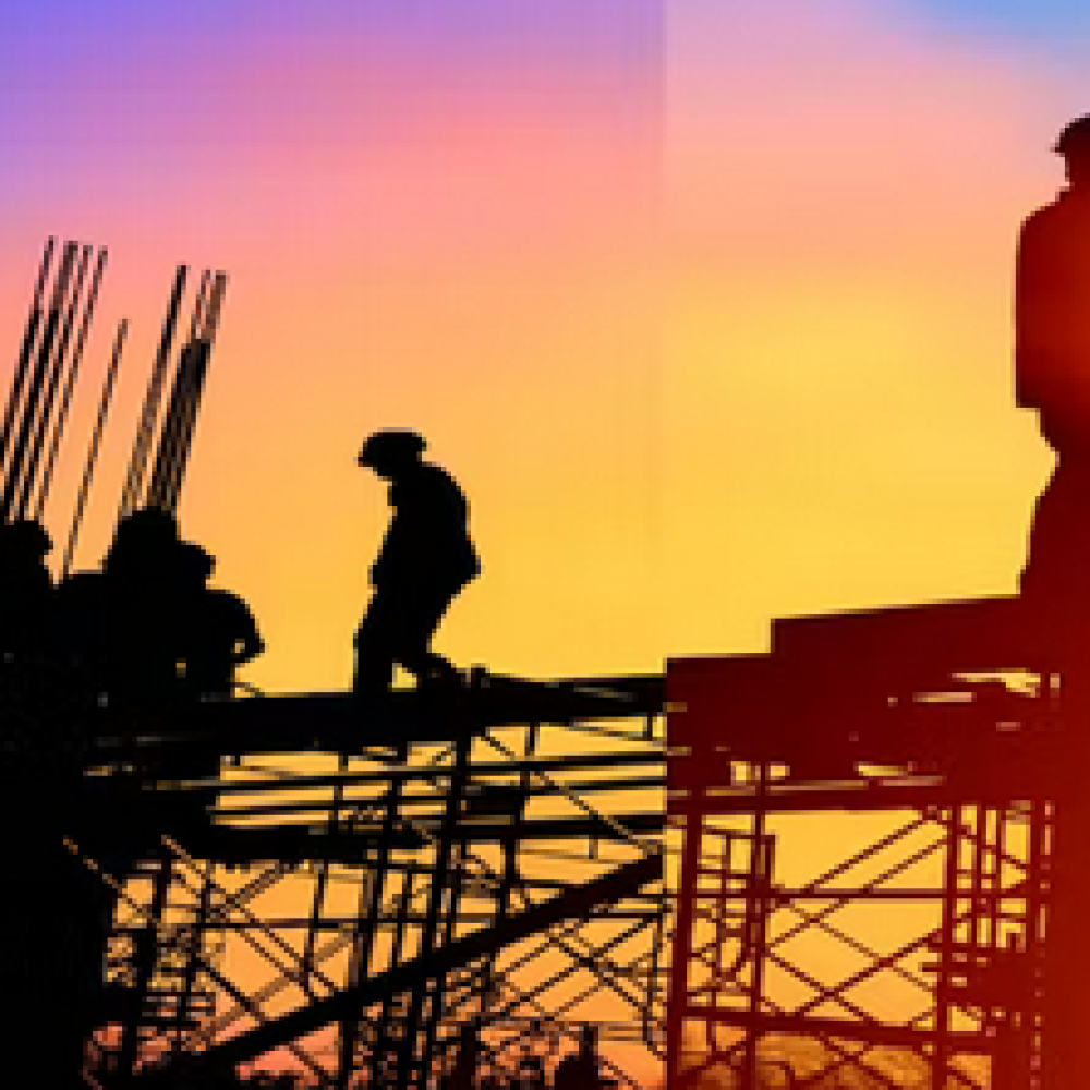 Workers silhouettes on a building site