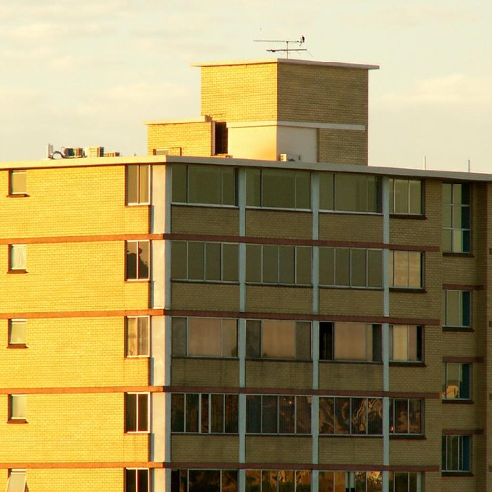 Apartment building lit up in the sunset