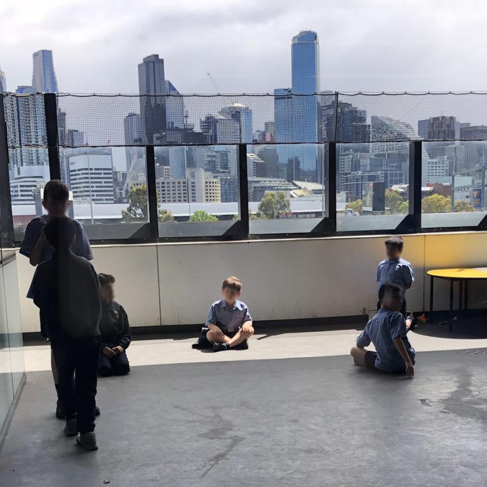 School children on a highrise balcony