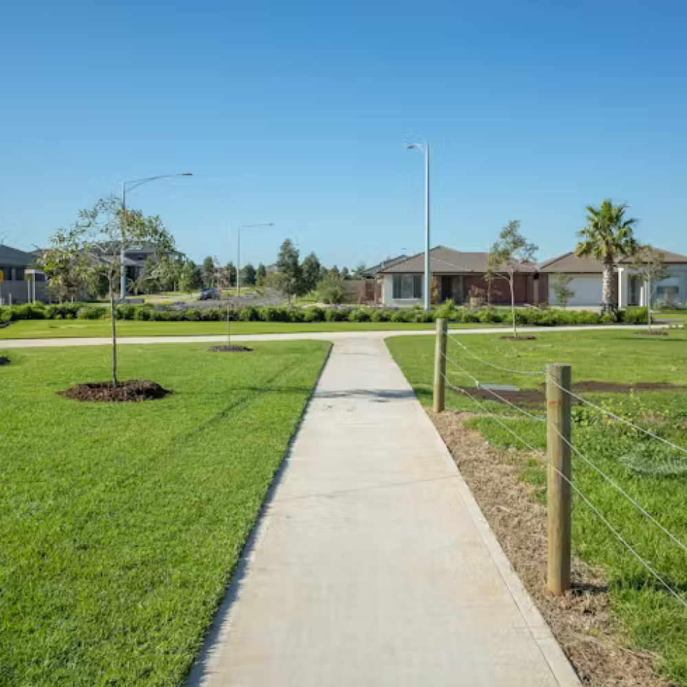 Walking down a footpath with green lawns