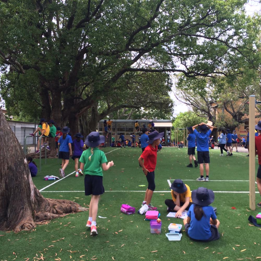 Soccer balls fly off the field, with the possibility of striking children playing on equipment around the grassed area.